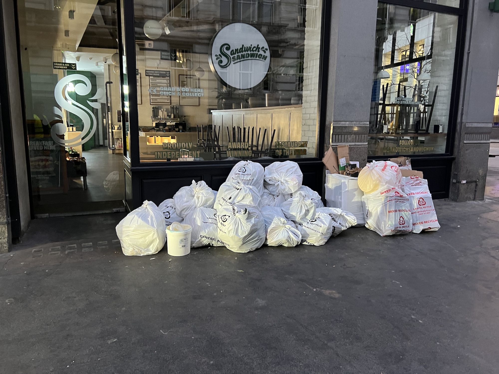 Capital Recycle branded bags ready for collection at a central London sandwich chain