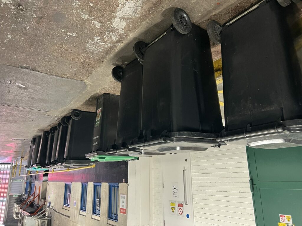 A row of Capital Recycle 660 litre commercial bins used to separate waste streams on a London site