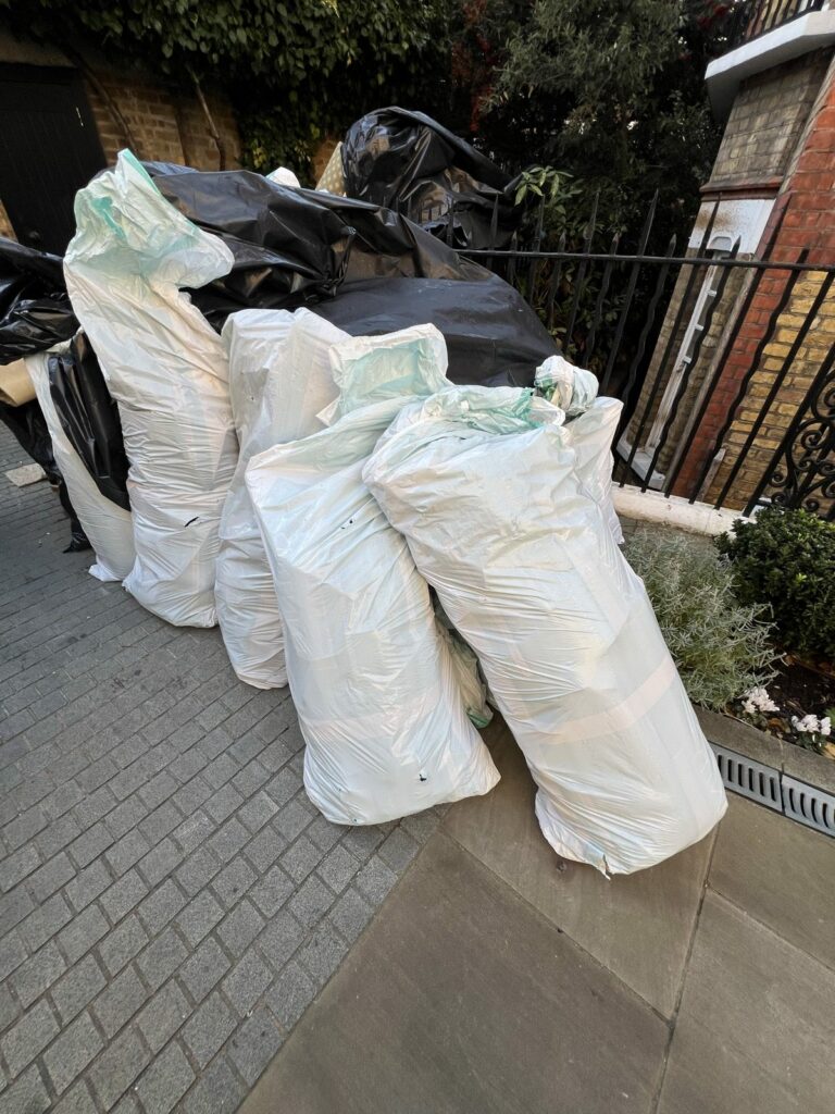 White woven sacks left out for collection on a London street