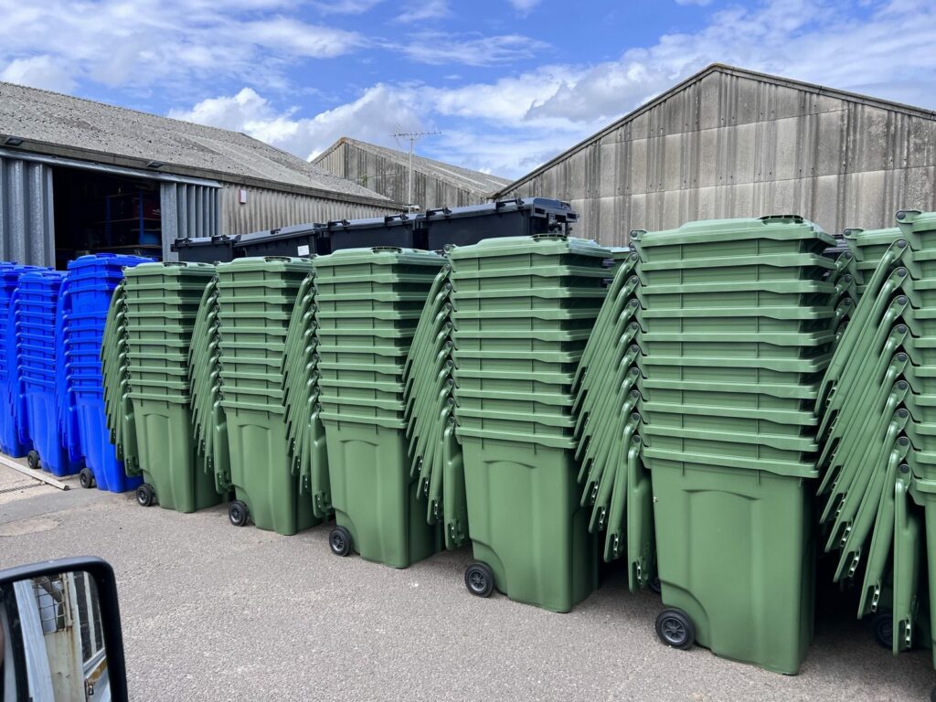 Two Capital Recycle 660 litre commercial wheelie bins on a London street