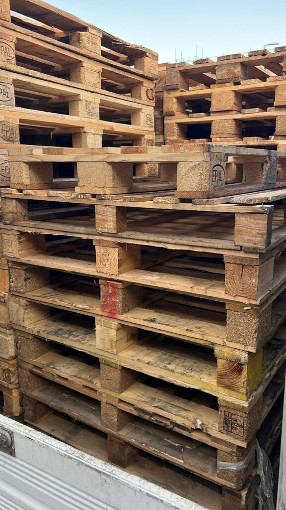 Used pallets stacked and loaded for collection in London