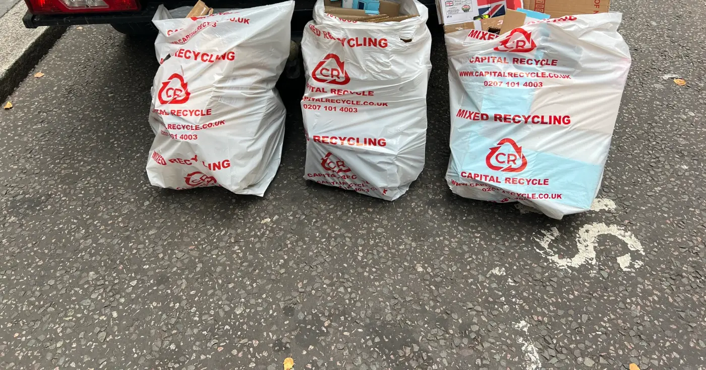 Office waste collection London: dry mixed recycling sacks with flattened cardboard loaded at the kerb