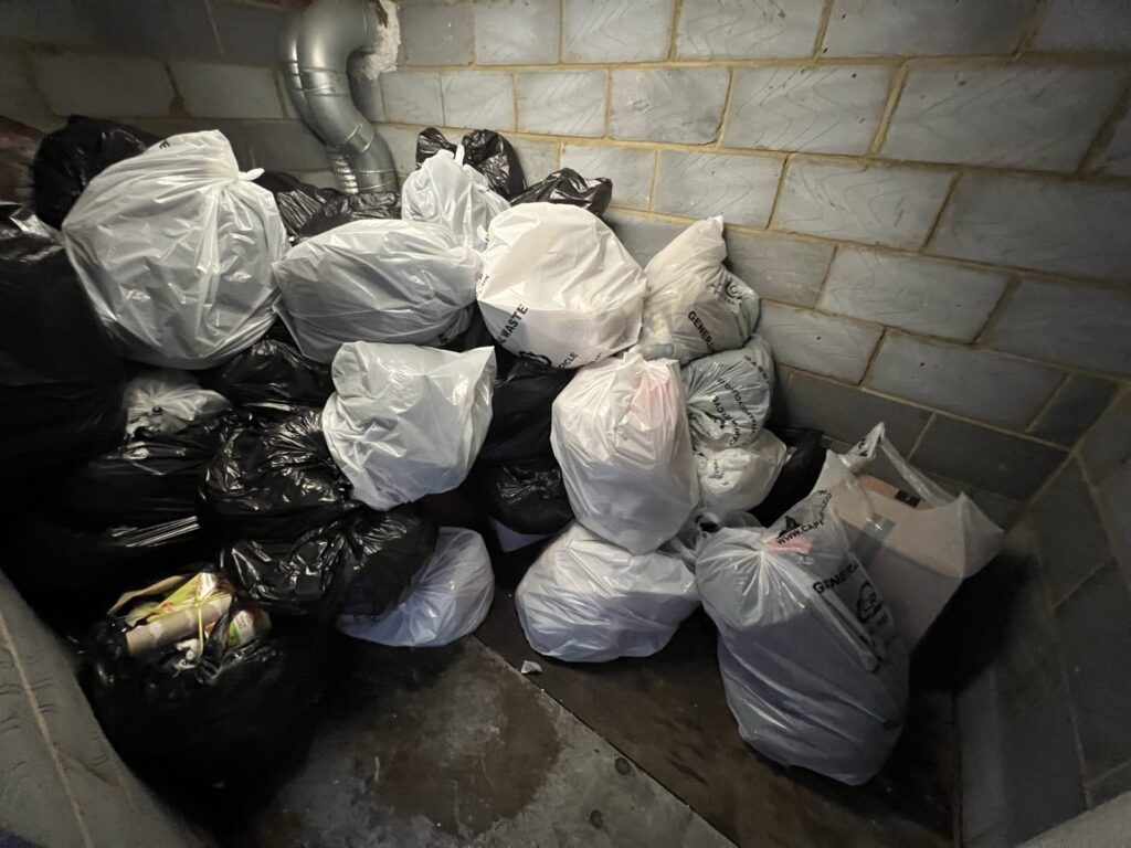 Waste sacks stacked in a commercial waste holding room ready for collection