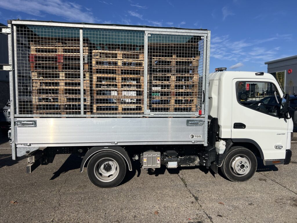 A full cage of used pallets loaded for collection in London